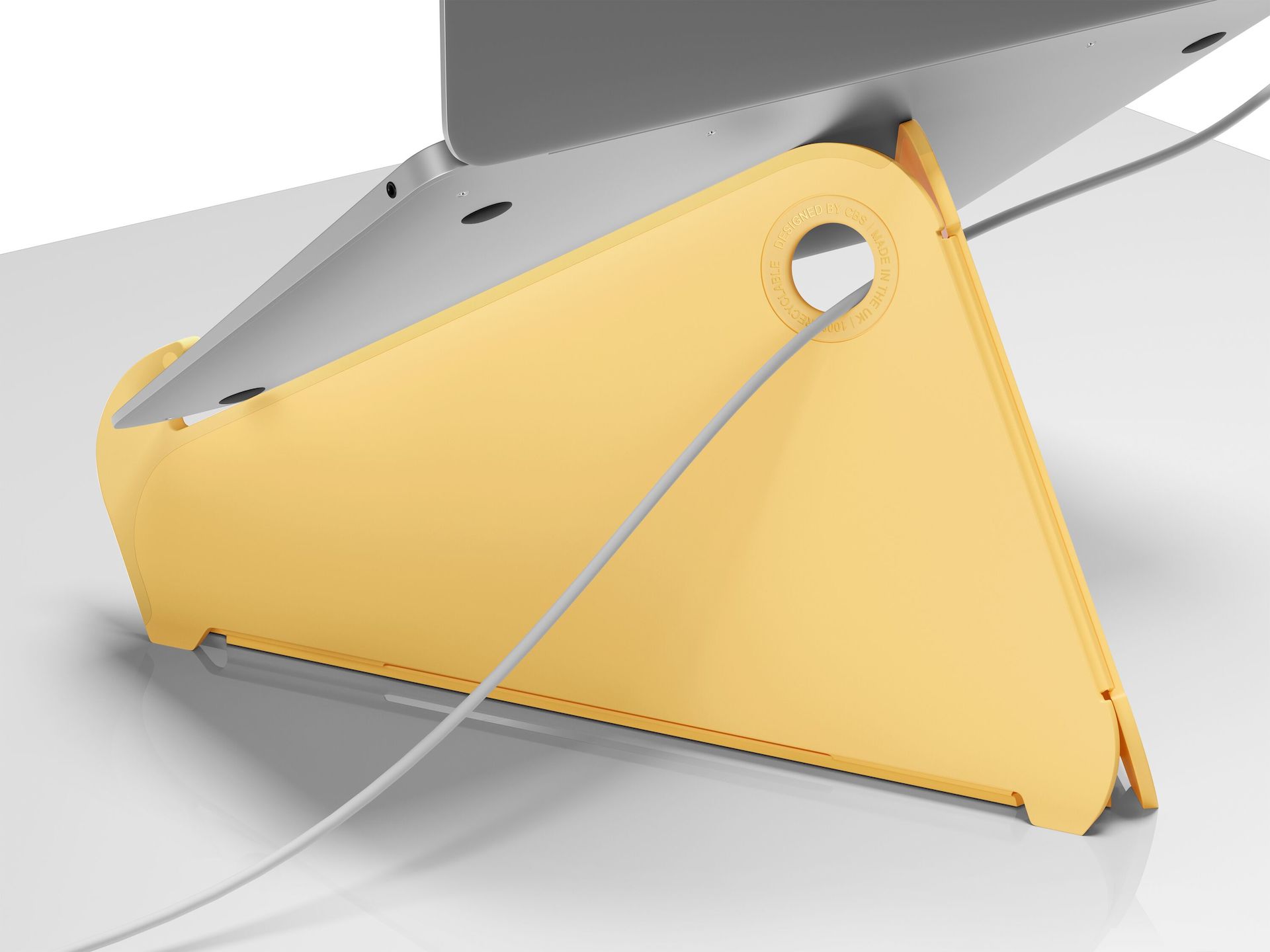 The back of an Oripura Laptop Stand in yellow with a power cable routed through its cable slots.