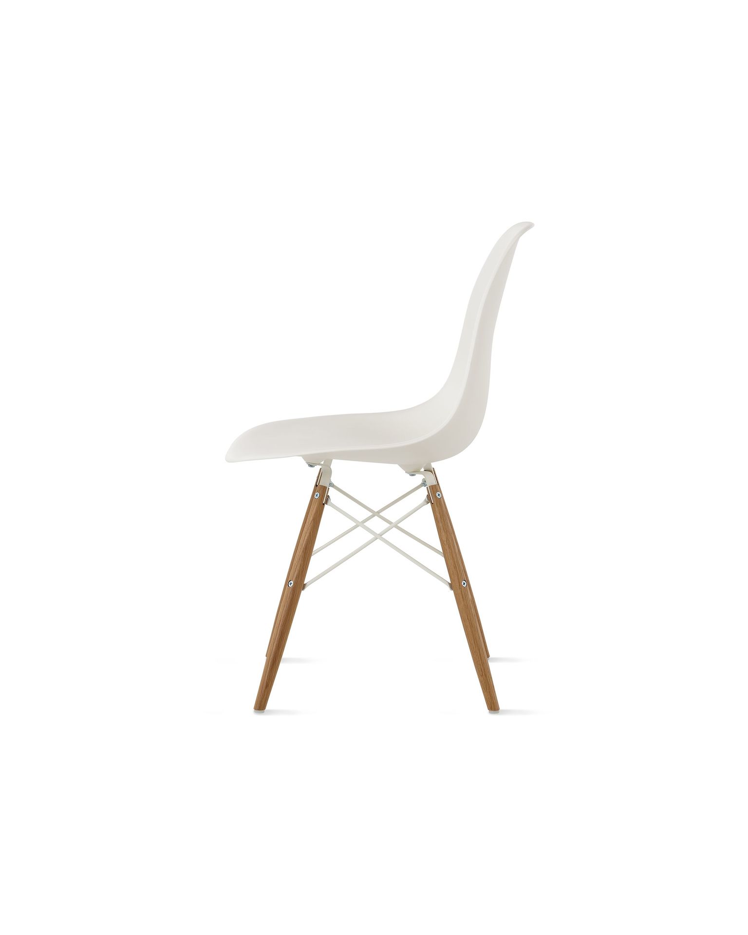 Side of white molded plastic shell chair  with dowel base for legs.