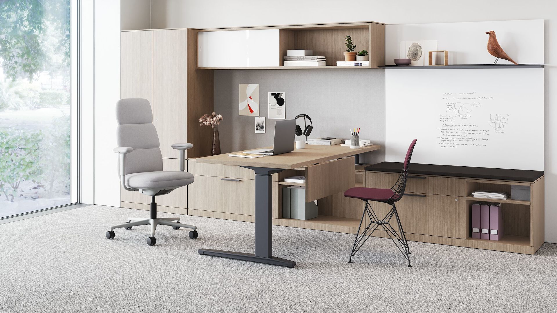A high-back Asari chair in light grey in a private office with storage, height adjustable desk and side chair. 