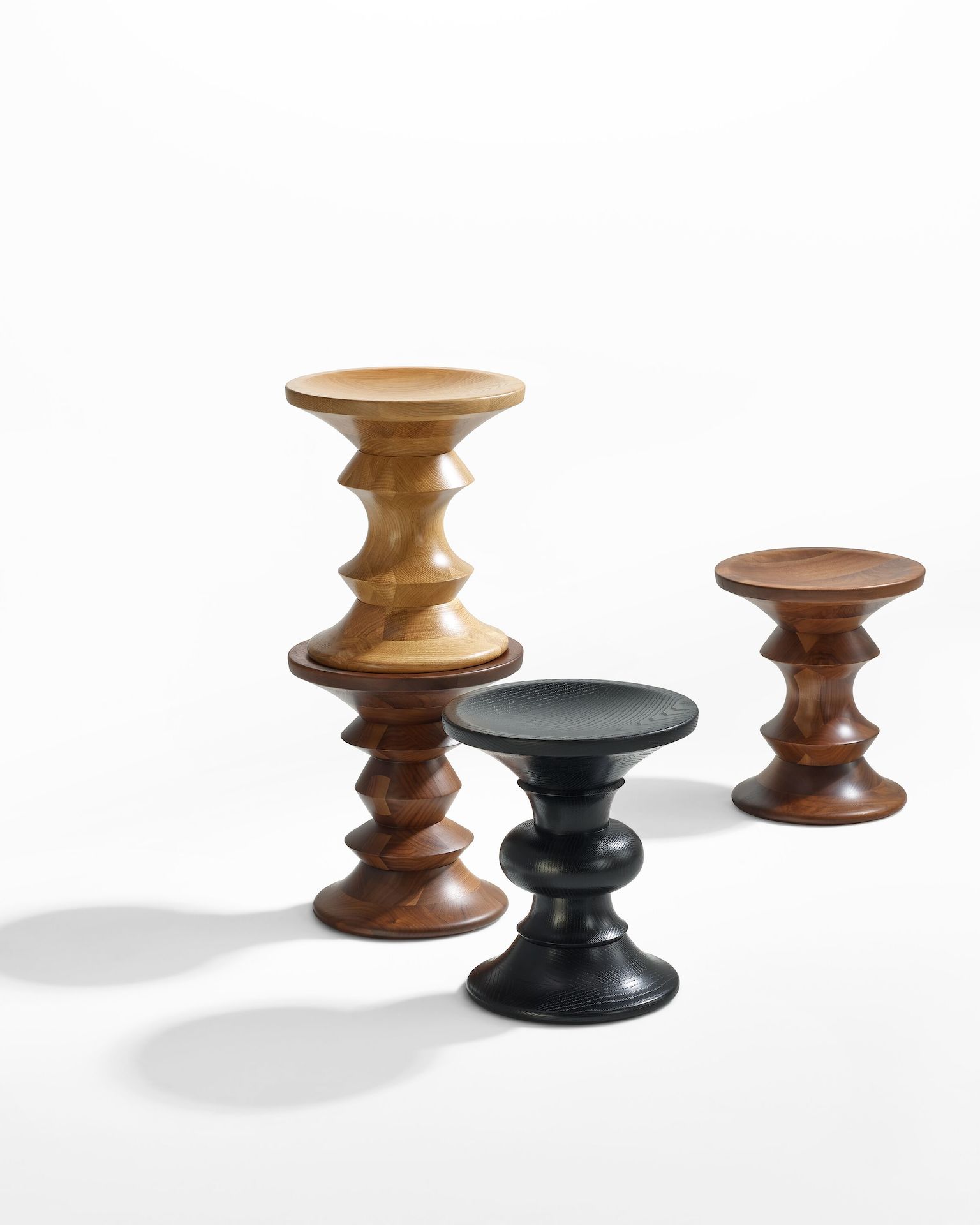 Group of four Eames Turned Stools in white oak, walnut and ebonized ash and in Shapes A, B, C and D.