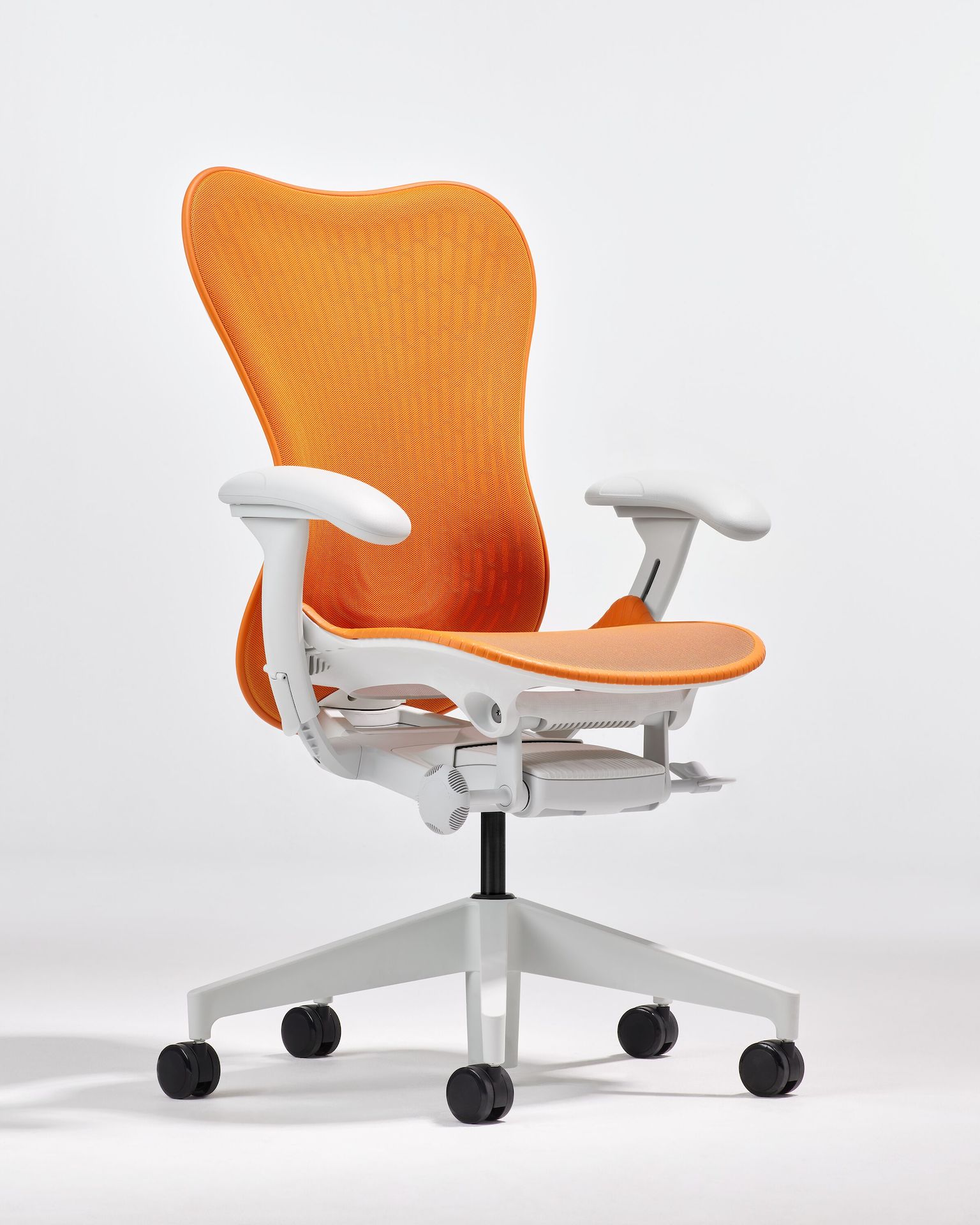 Front angle view of a Mirra 2 chair with a Butterfly back in ochre and alpine frame.