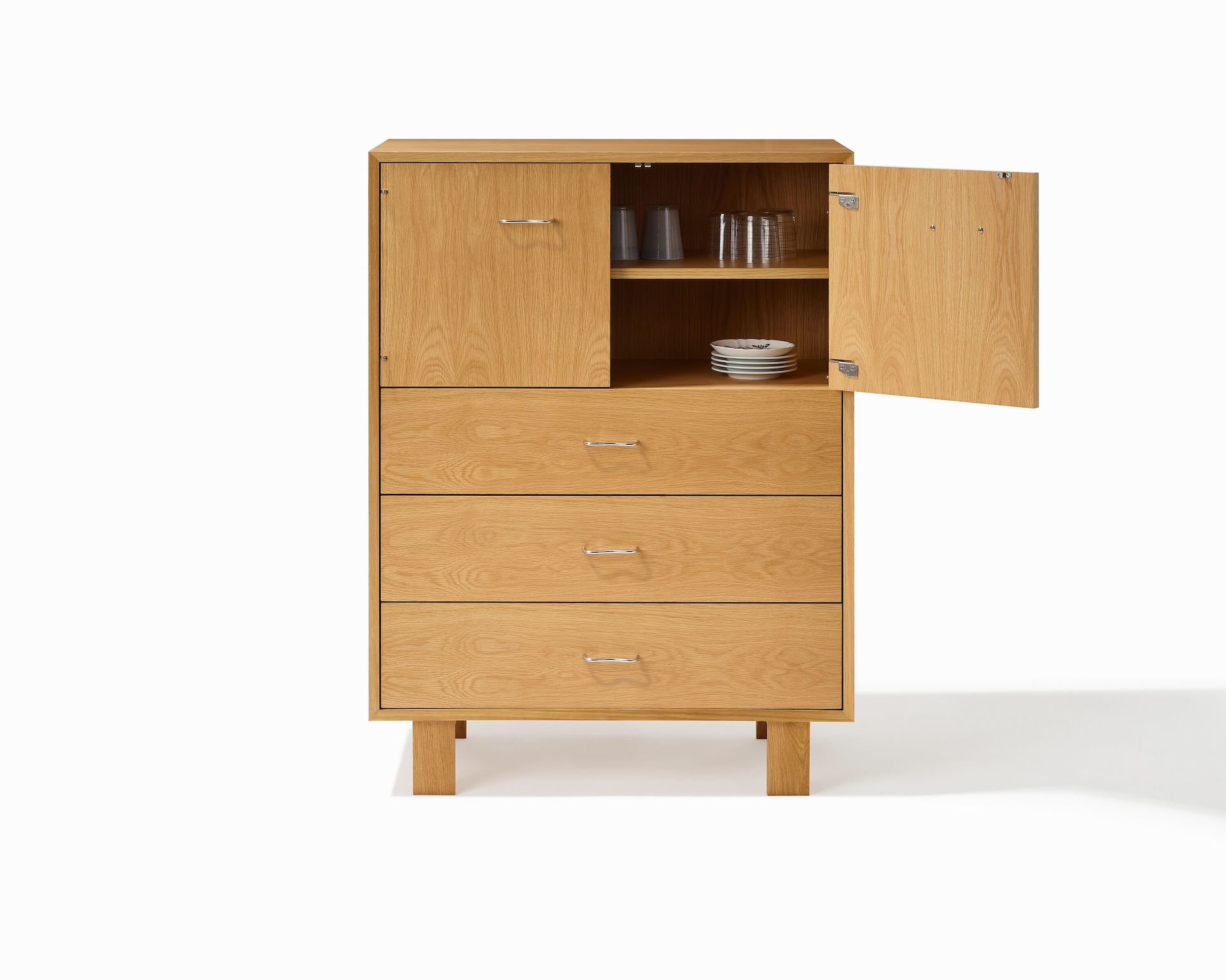 Nelson Basic Console in oak with two doors, three drawers, wavy pulls, and standard square legs. 