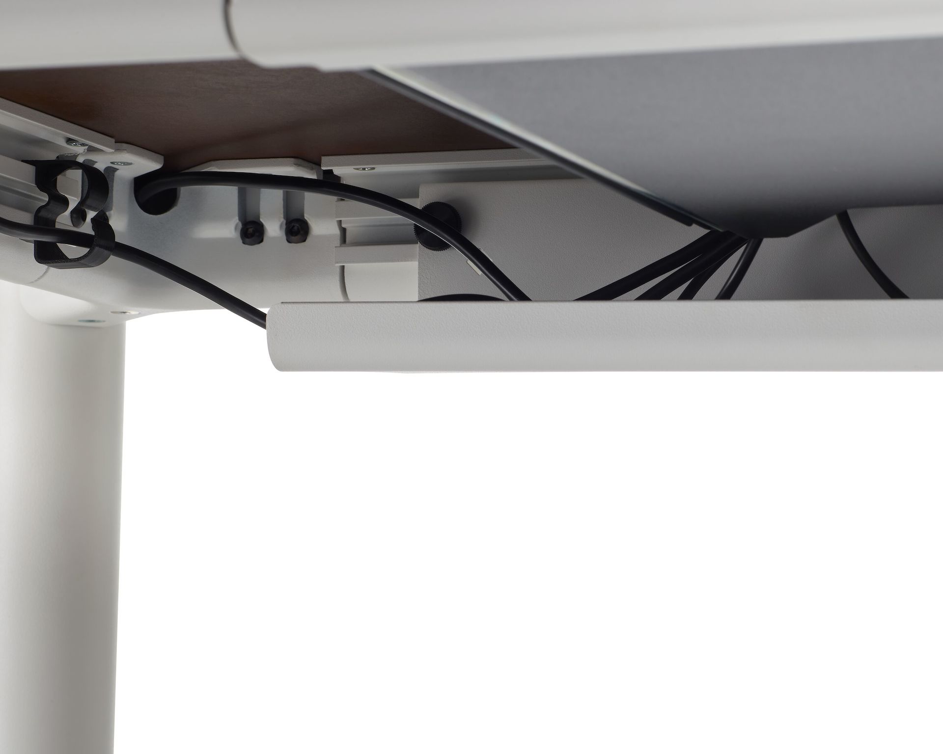 Undersurface of the four leg height-adjustable table showing cable tray and wire management. 
