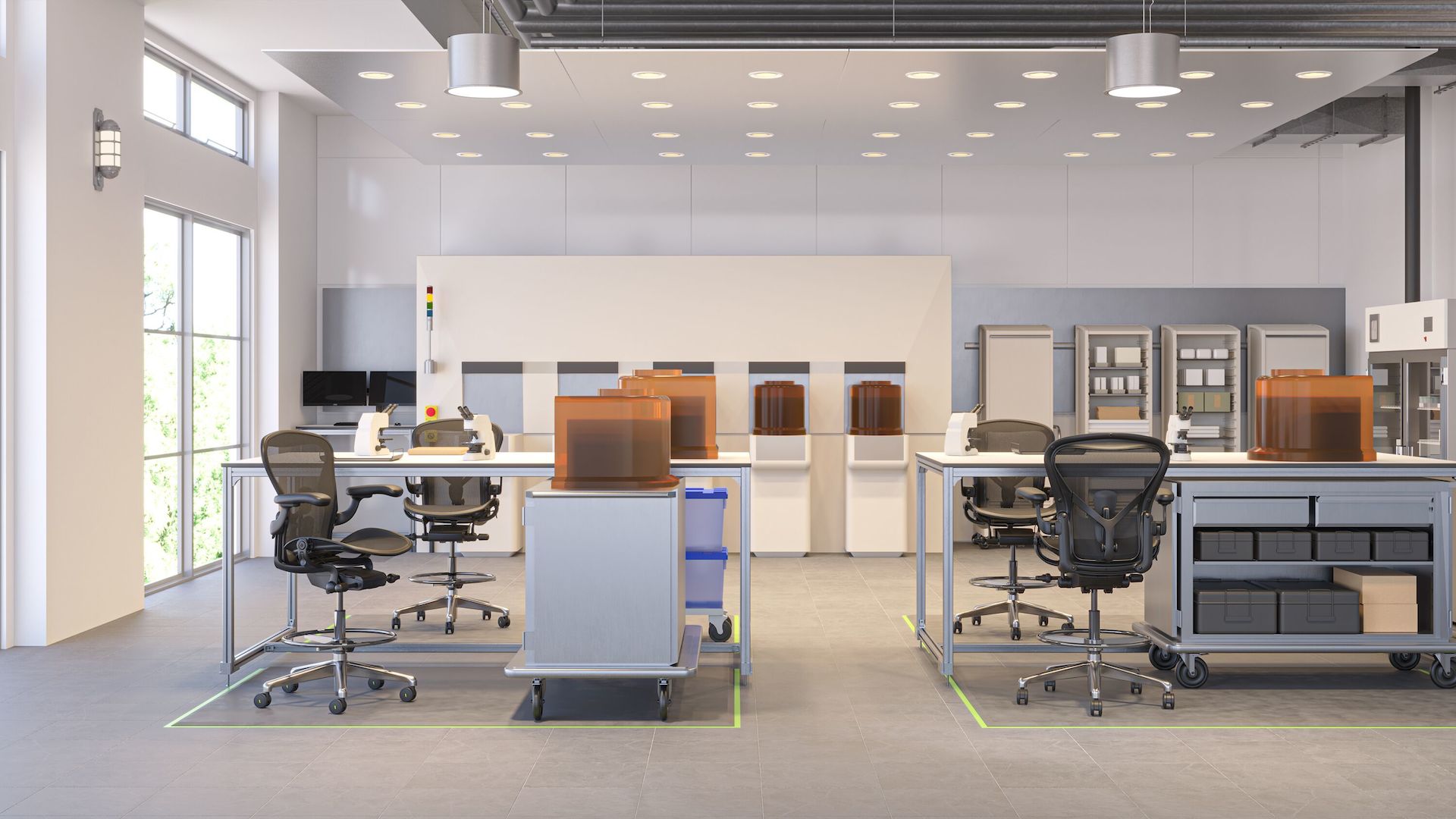 Two Aeron ESD stools are at two front stations in a cleanroom setting and another ESD Stool is at a station  in the  back.