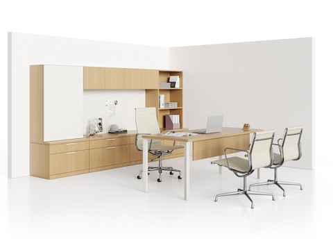 A Canvas Private Office environment with three tan leather Eames Aluminum Group Chairs.