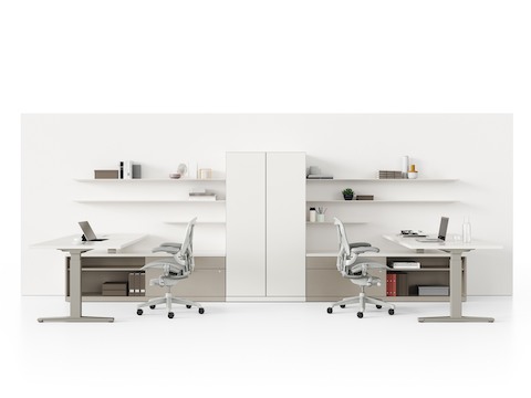 Dual workstations with light gray Aeron Chairs, Renew Sit-to-Stand Tables, and Canvas Private Office storage, including floating shelves and a shared tower.