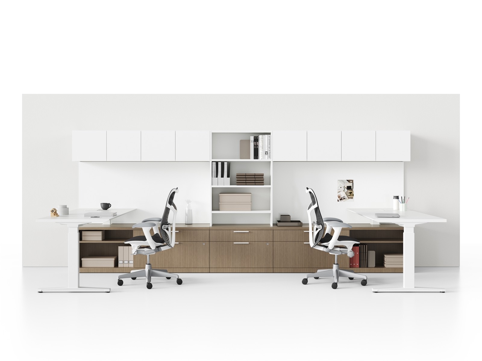 Dual workstations with black Mirra 2 Chairs, Renew Sit-to-Stand Tables, and Canvas Private Office storage, including overheads and a shared bookcase.
