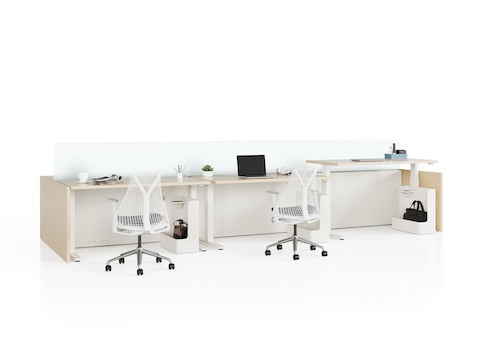 Canvas Channel workstations with wood sit-to-stand tables, glass screens, and Sayl Chairs.