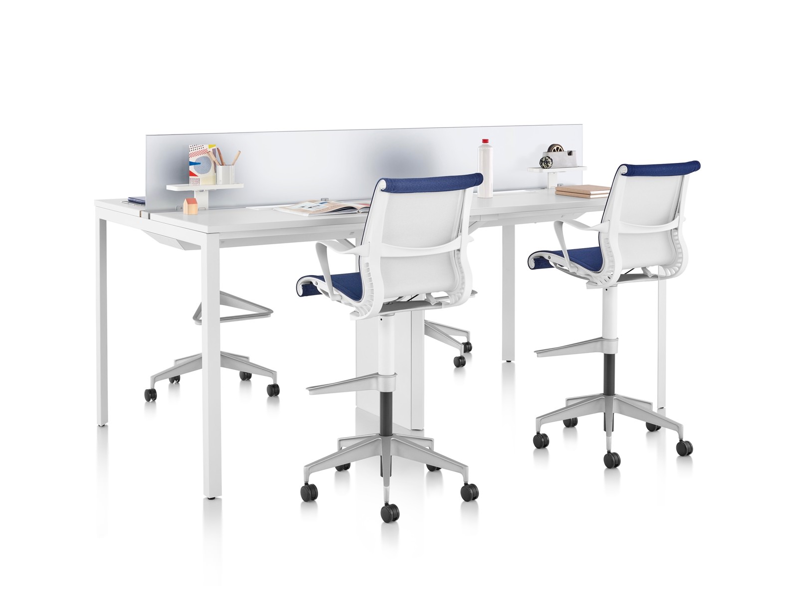 Four short-term workpoints created by a high Layout Studio table and blue Setu Stools.