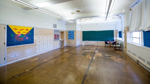 An interior photograph of an empty classroom without desks or chairs. An interior photograph of an empty classroom without desks or chairs.