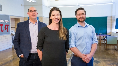 Three Herman Miller employees stand in an empty classroom. Three Herman Miller employees stand in an empty classroom.