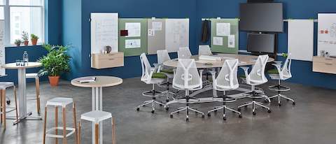 Several white Sayl office chairs surround an Exclave conference table in an open collaboration space.