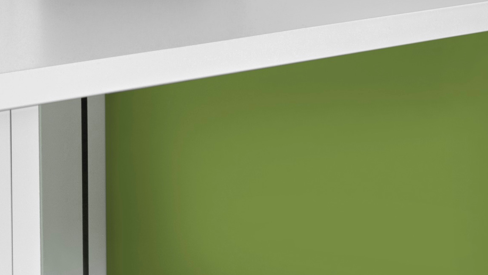 Close-up of a green painted panel on part of a workstation.