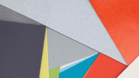 Layers of multi-coloured fabric and material swatches showing the various textures, finishes and materials available.