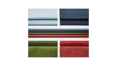 Four folded, matte fabric swatches in light blue, blue, green, and red.