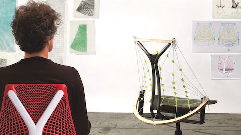 Designer Yves Béhar examines a model of the Sayl office chair. Designer Yves Béhar examines a model of the Sayl office chair.
