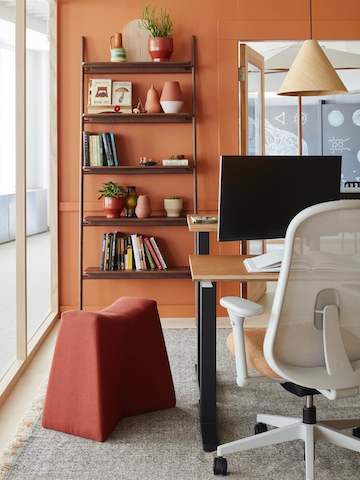 A close-up image of an indoor/outdoor office space with Motia Sit-to-Stand Tables, Lino office chairs, and hanging Hay pendant lamps.