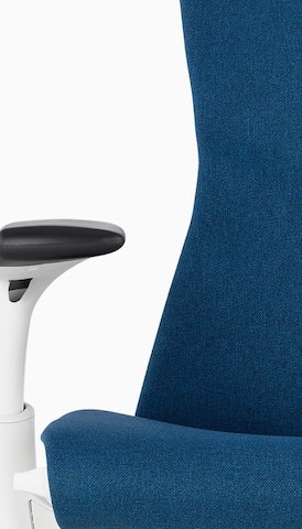 Close-up of the back and arm of a blue Embody office chair. Select to go to the Seating product page.