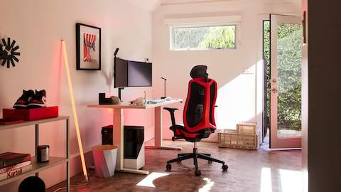 A gaming setup featuring the Vantum Gaming Chair and Nevi Gaming Desk by Herman Miller Gaming.