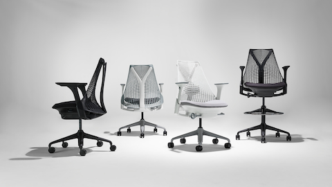 Three Sayl chairs in black, white and fog, and one Sayl stool in black.