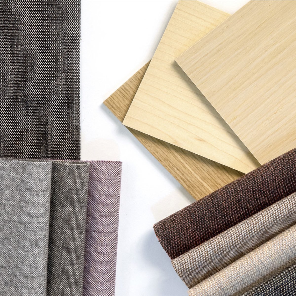 An overhead view of a variety of material samples including fabrics, and laminates in a range of colors.