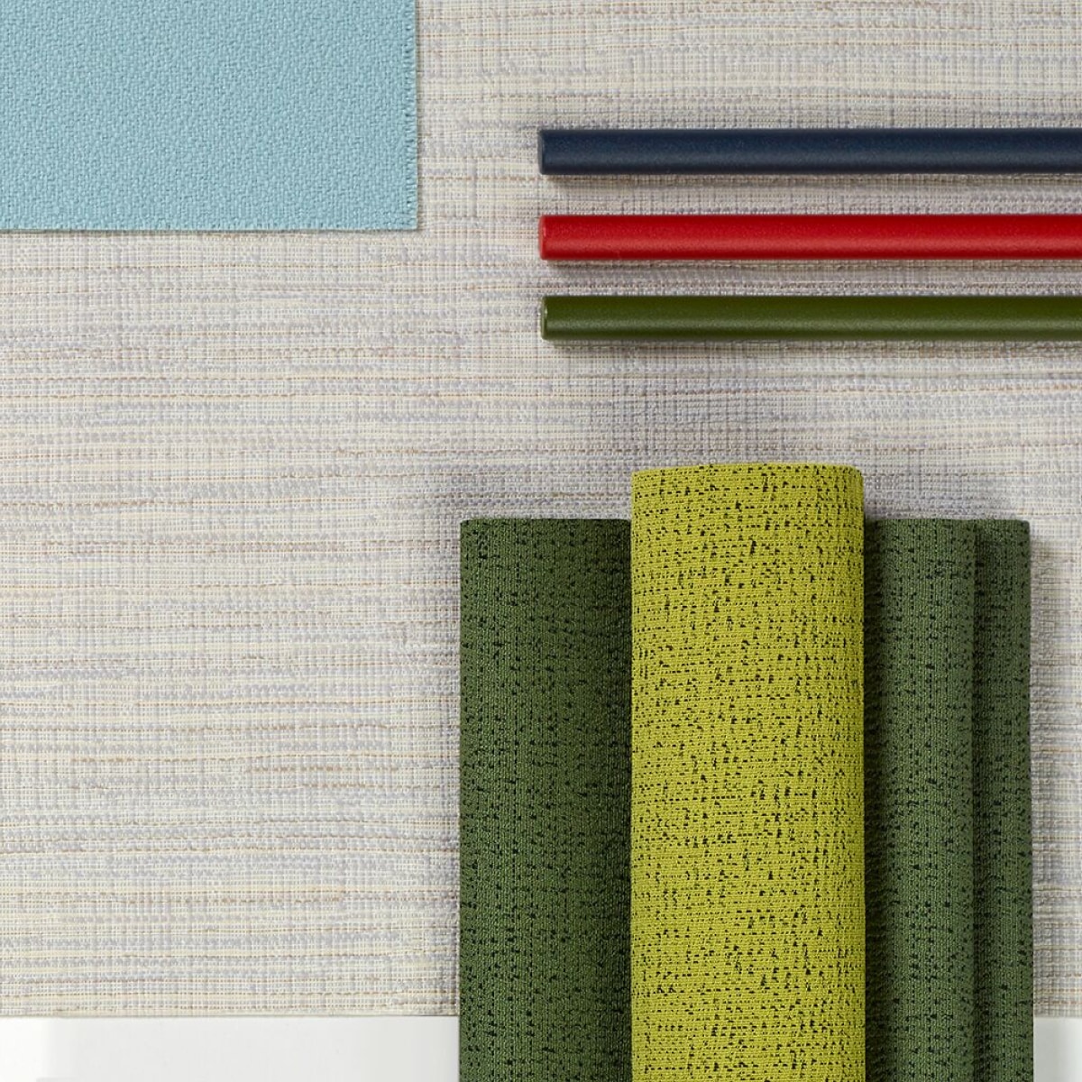 A top view of multiple, folded colourful and neutral fabrics.