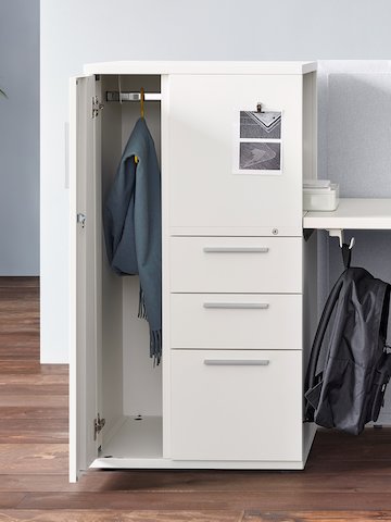 A white Tu Metal Storage cabinet with an open door and three closed drawers.