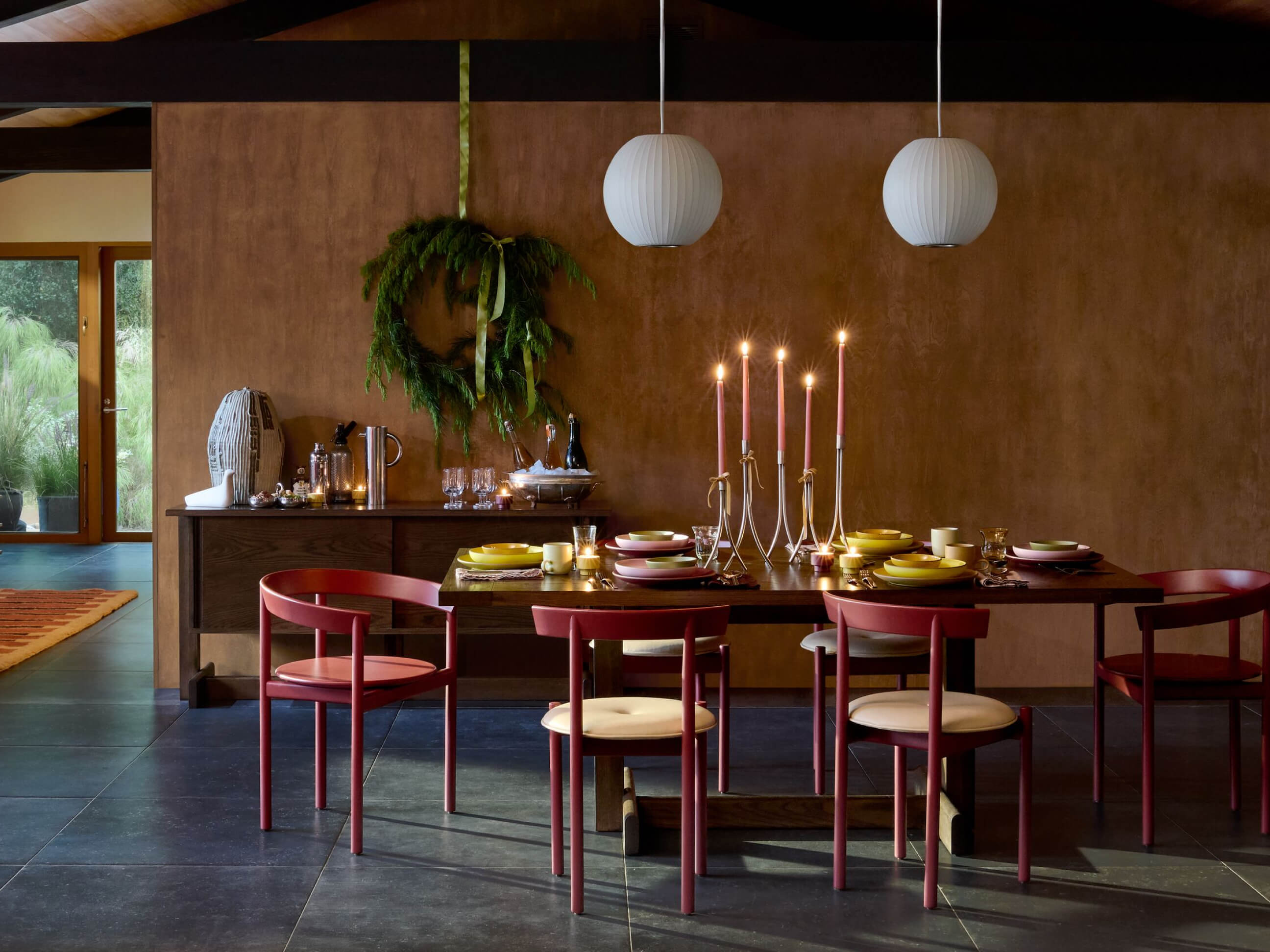 Land Table in oak with red comma chairs surrounding, and Heath earthenware on top