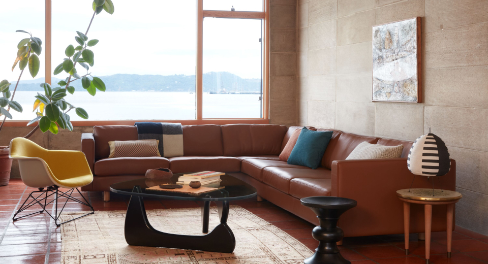 Upholstered in a soft chocolate leather, the Lispenard Sofa completes a modern living space with the Noguchi Table and Eames Turned Stool.