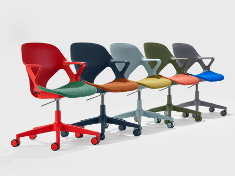 Five Zeph chairs with fixed arms in a line including a red chair with green seat pad, dark blue chair with orange seat pad, light blue chair with yellow seat pad, olive chair with light orange seat pad and a grey chair with a blue seat pad.