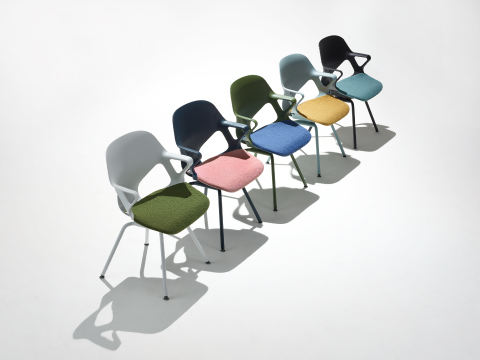 Five Zeph side chairs with fixed arms in a line including an alpine chair with olive seat pad, dark blue chair with pink seat pad, light blue chair with yellow seat pad, olive chair with blue seat pad and a black chair with a light green seat pad.