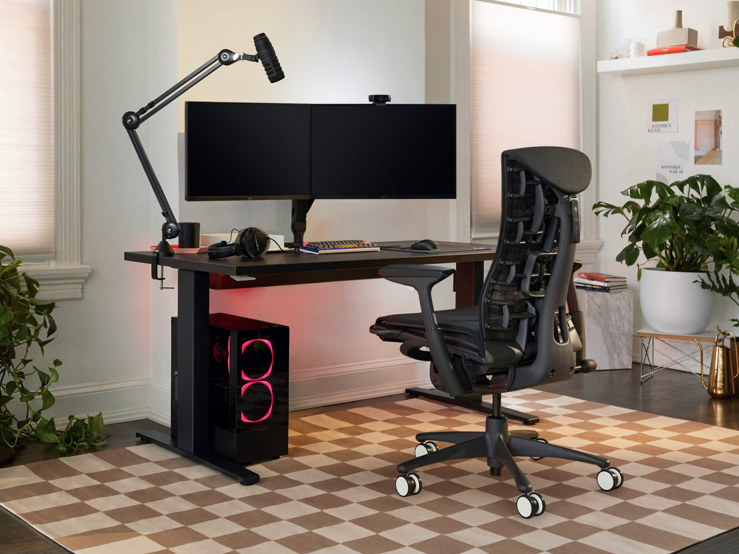 Fully ergonomic gaming setup with a slim, futuristic gaming chair and sit-to-stand gaming desk.