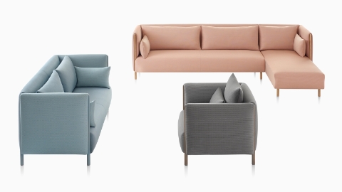 Three ColourForm seating pieces—blue sofa, salmon sectional, and gray lounge chair—against a white background.