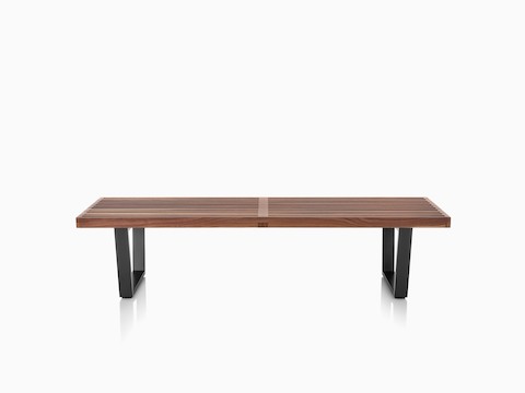 A Nelson Platform Bench with a medium wood finish and black legs.