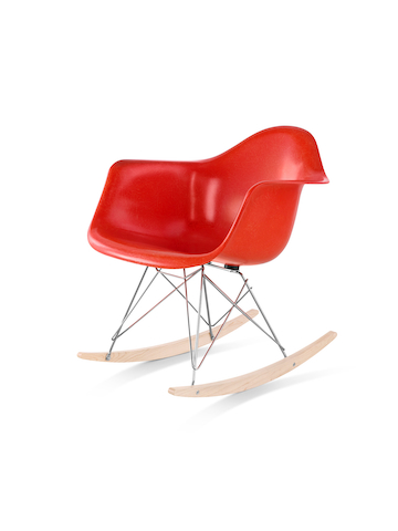 A red Eames Molded Fiberglass rocker, viewed from a 45-degree angle.