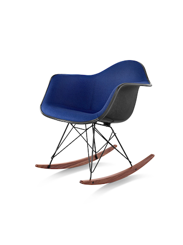 An Eames Molded Fiberglass rocker with blue upholstery, viewed from a 45-degree angle.