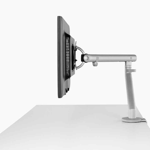 A detailed view of a monitor arm attached to an AbakEnvionments Desk. 