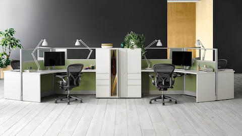 Black Aeron ergonomic desk chairs at Action Office workstations in an open office. Black Aeron ergonomic desk chairs at Action Office workstations in an open office.