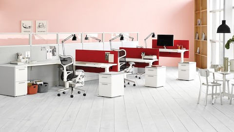 Action Office workstations with glass dividing walls with black Mirra 2 ergonomic desk chairs.