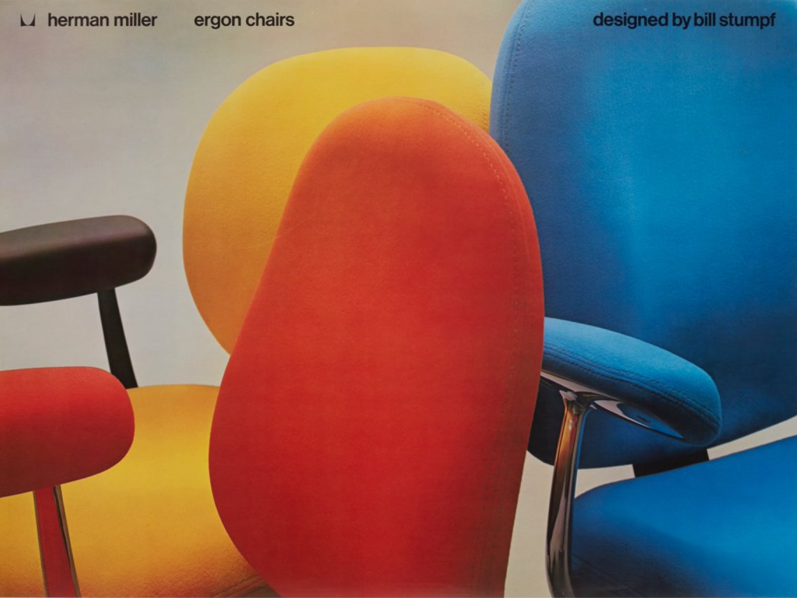 Três cadeiras Ergon exibidas em vermelho, amarelo e azul.