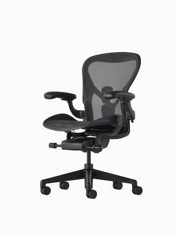Black Aeron Chair on a white background with a 5-star base and ergonomic back support, viewed at an angle. Select to view the Aeron Chair product page.