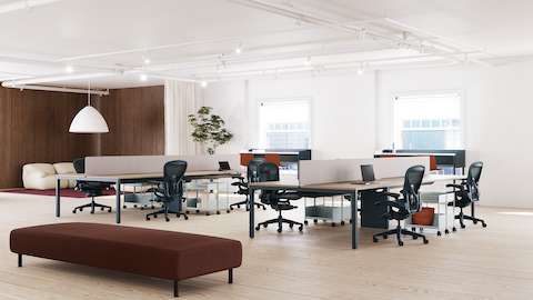 Two sets of workstations, each with Aeron chairs in dark blue.