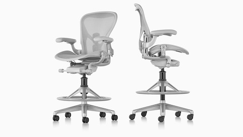 Views from an angle and profile of two light grey Aeron Stools.