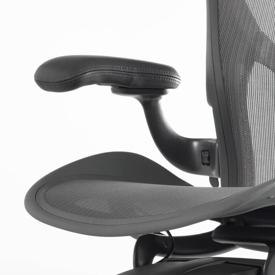 A close-up view of a leather arm pad on an Aeron Stool.