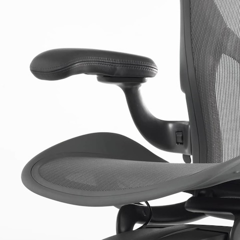 A close up view of a leather arm pad on an Aeron Stool.