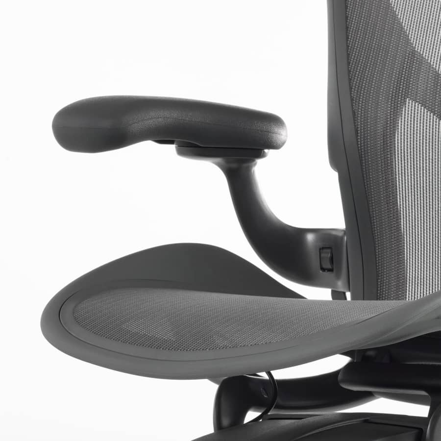 A close up view of a non-upholstered arm pad on an Aeron Stool.