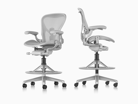 Views from an angle and profile of two light gray Aeron Stools.