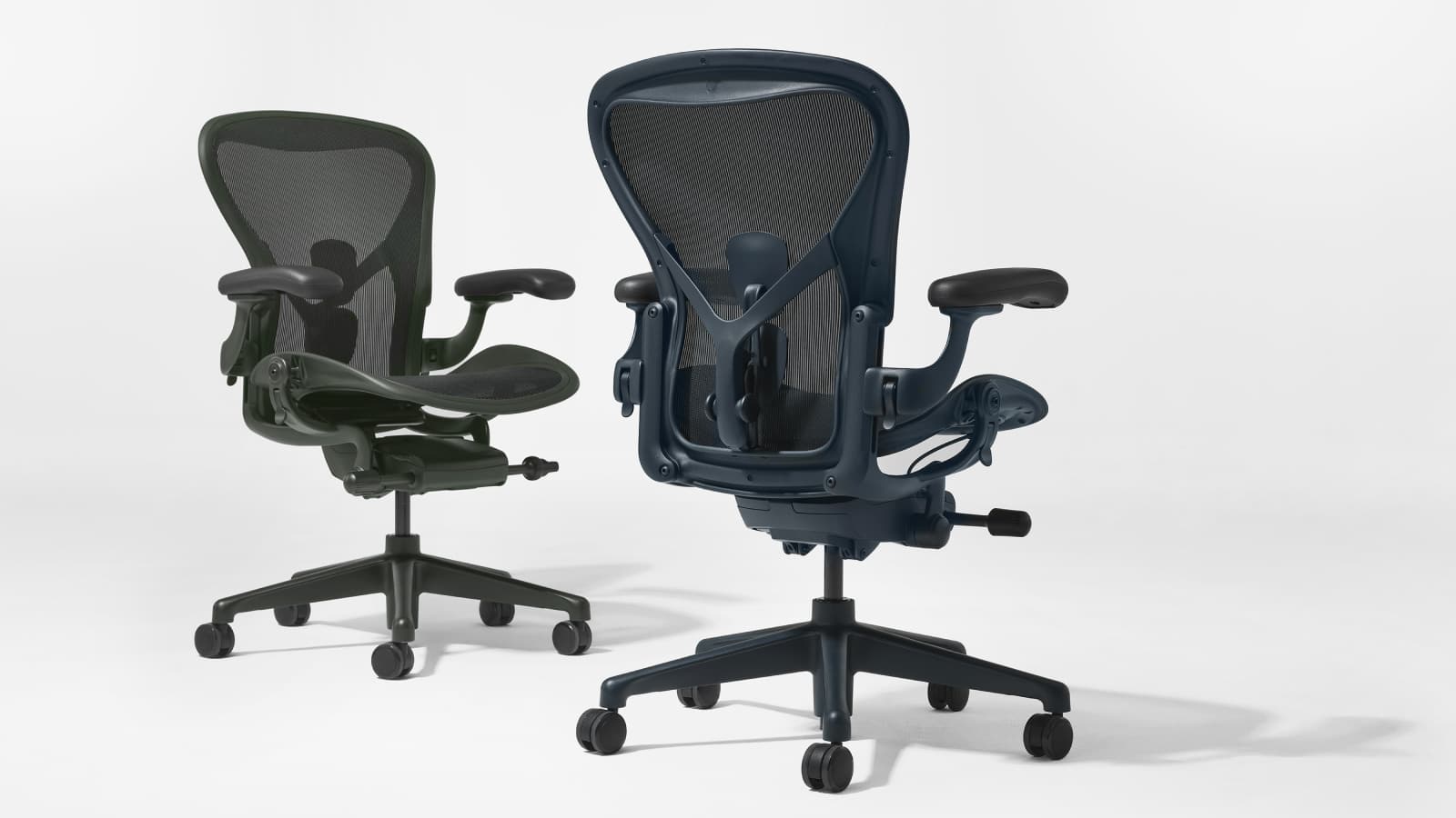 Aeron chairs in dark green and dark blue beside each other.