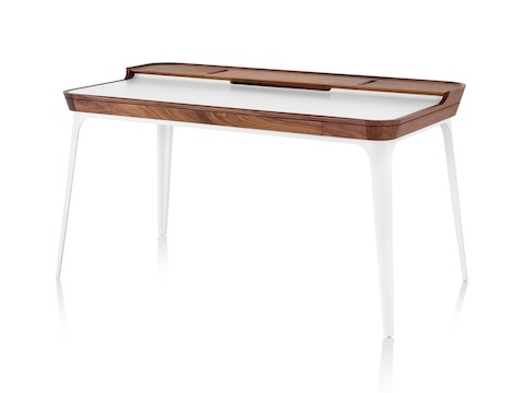 Three quarter profile view of white Herman Miller Airia Desk with dark wood trim and white legs. Three quarter profile view of white Herman Miller Airia Desk with dark wood trim and white legs.