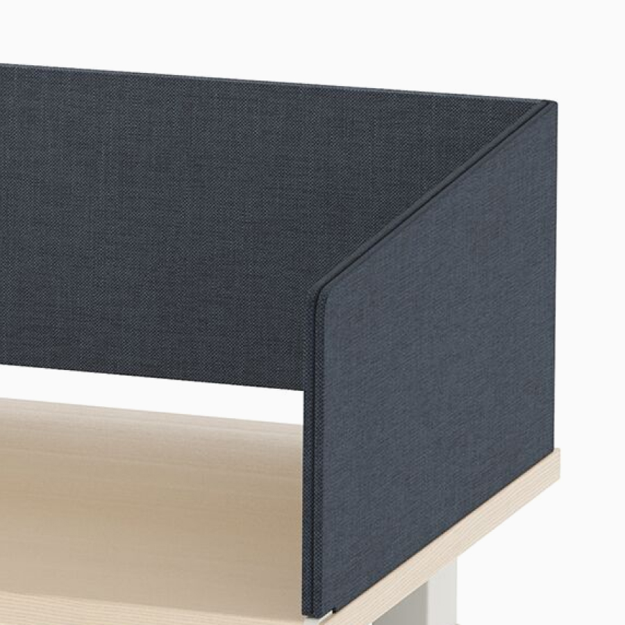 Open, navy metal storage attached to laminate surface of desk with navy fabric wrapped screen.
